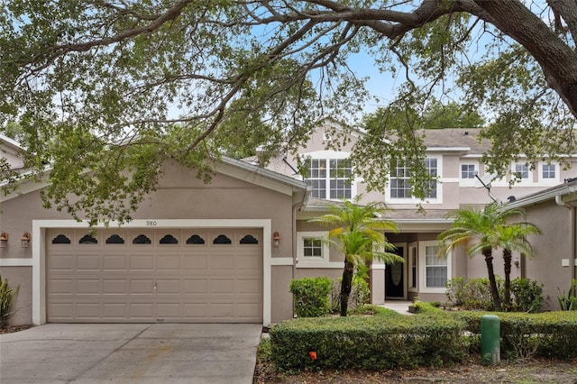 980 Crestwood Commons Ave, Ocoee, FL 34761 - view of front of home with stucco siding, concrete driveway, and a garage