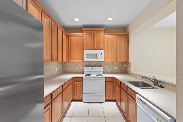 980 Crestwood Commons Ave, Ocoee, FL 34761 - kitchen with white appliances, a sink, light countertops, decorative backsplash, and recessed lighting