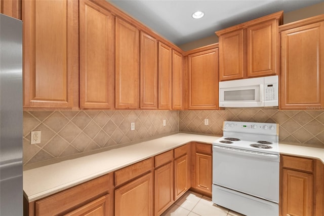 980 Crestwood Commons Ave, Ocoee, FL 34761 - kitchen featuring white appliances, light countertops, light tile patterned floors, tasteful backsplash, and recessed lighting