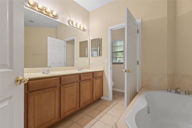 980 Crestwood Commons Ave, Ocoee, FL 34761 - bathroom with double vanity, a bath, toilet, and tile patterned floors