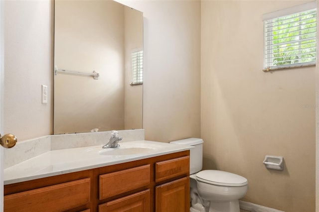 980 Crestwood Commons Ave, Ocoee, FL 34761 - half bathroom featuring toilet, vanity, and baseboards