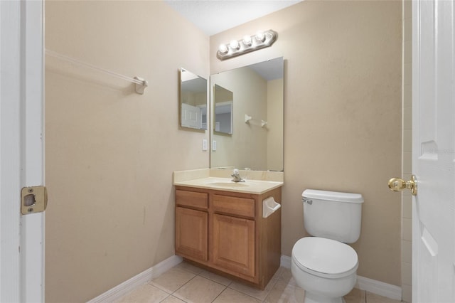 980 Crestwood Commons Ave, Ocoee, FL 34761 - bathroom with vanity, toilet, tile patterned flooring, and baseboards