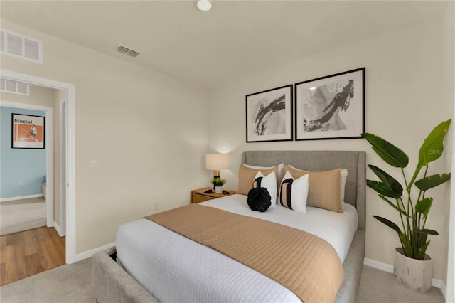 bedroom featuring light colored carpet