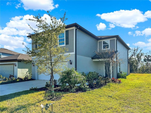 view of front of home with a garage and a front lawn