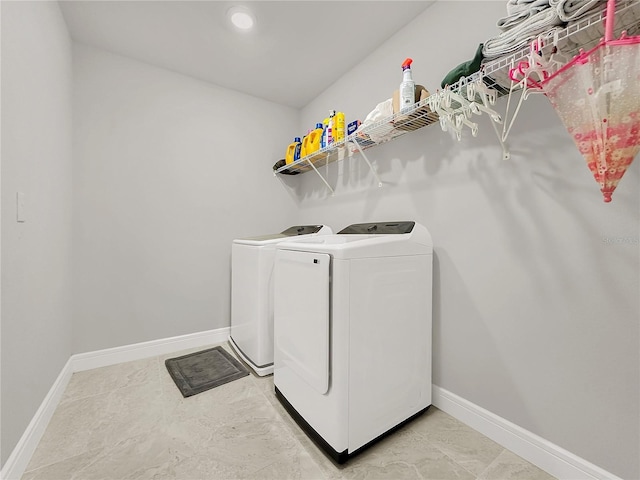 laundry room featuring washing machine and clothes dryer