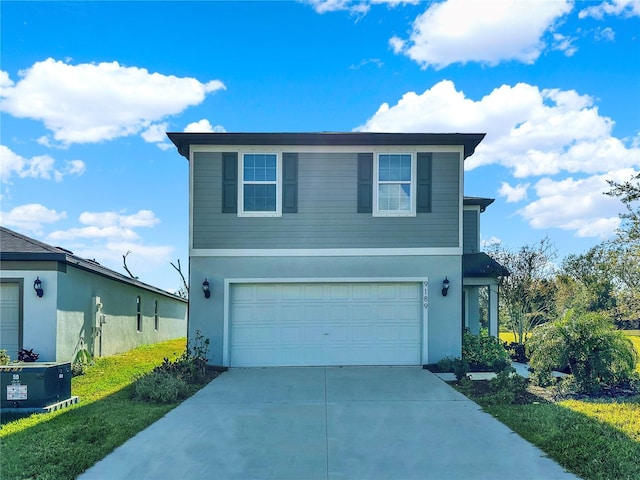 front of property featuring a garage and central air condition unit