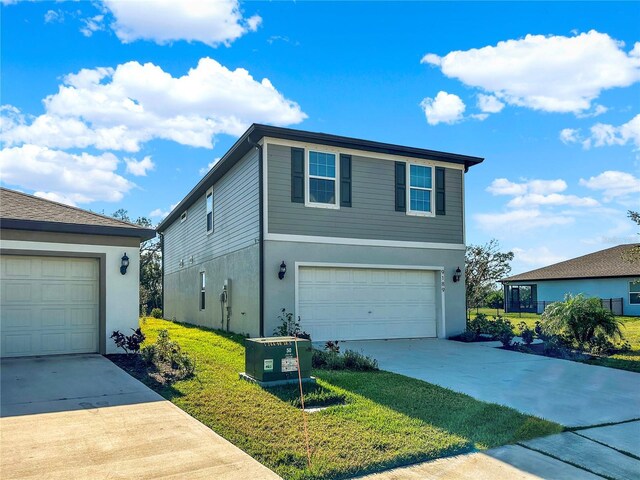9189 Royal River Cir, Parrish, FL 34219 - view of front of house with concrete driveway, stucco siding, and an attached garage