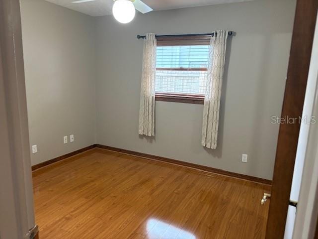 empty room featuring ceiling fan and hardwood / wood-style floors