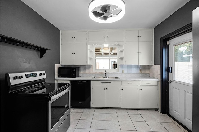 kitchen with white cabinetry, sink, tasteful backsplash, and black appliances