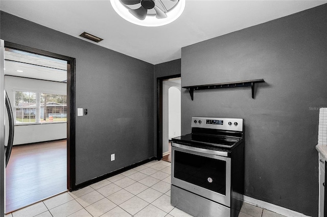 kitchen with stainless steel electric range oven and light tile patterned floors