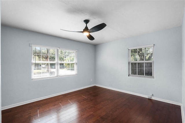 unfurnished room with dark hardwood / wood-style floors and ceiling fan