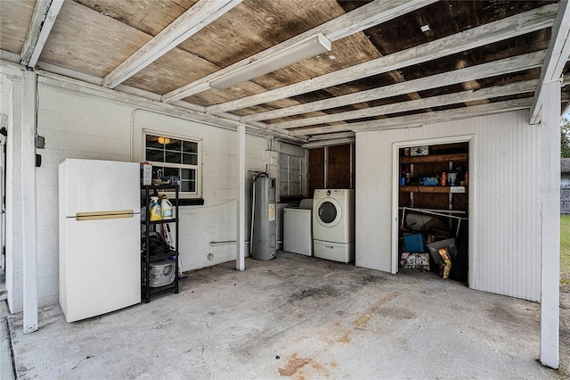 basement with washer and dryer, white fridge, and electric water heater