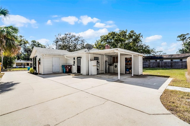 garage with white refrigerator and a yard