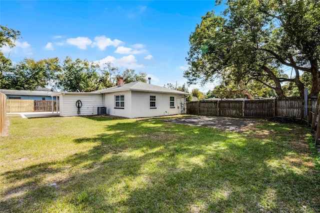 back of property featuring a yard, a patio, and central air condition unit