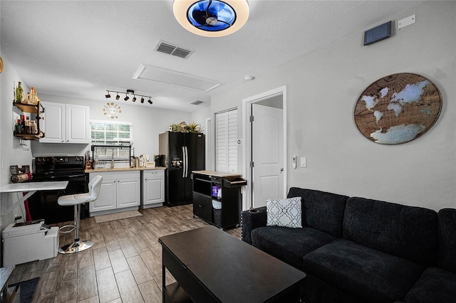 living room featuring a textured ceiling and light wood-type flooring