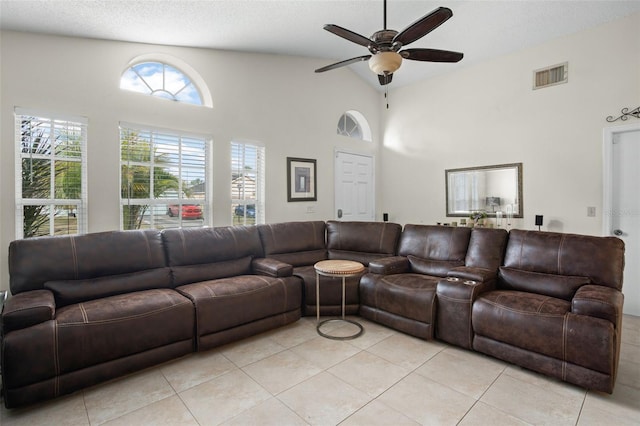 tiled living room with high vaulted ceiling, a textured ceiling, and ceiling fan