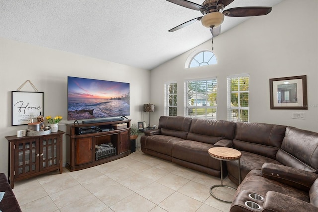 tiled living room featuring ceiling fan, lofted ceiling, and a textured ceiling