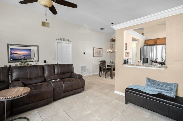 tiled living room featuring ornamental molding and ceiling fan with notable chandelier