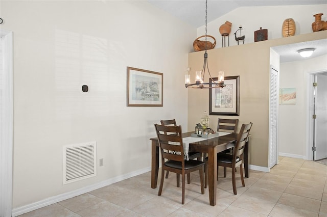 dining room featuring light tile patterned flooring, lofted ceiling, and a notable chandelier