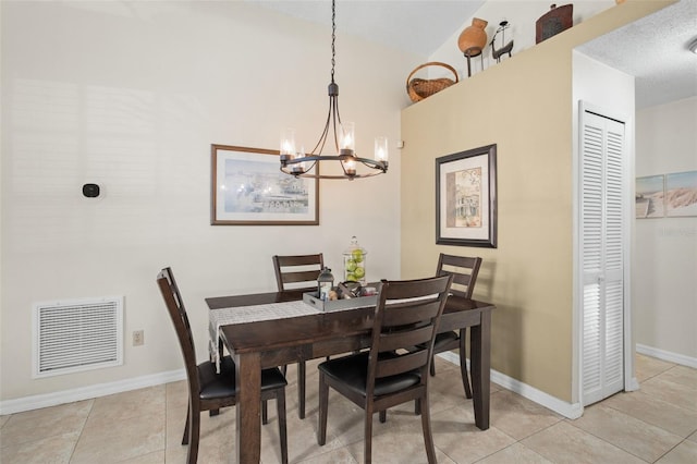 dining space with light tile patterned floors and a notable chandelier