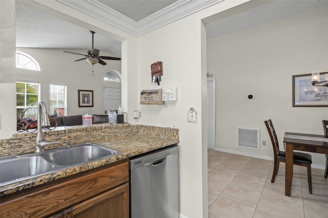 kitchen featuring lofted ceiling, sink, dark stone countertops, light tile patterned flooring, and stainless steel dishwasher