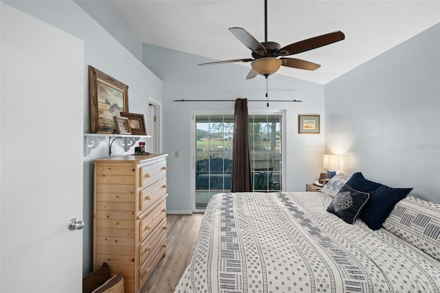 bedroom featuring ceiling fan, vaulted ceiling, light hardwood / wood-style flooring, and access to outside