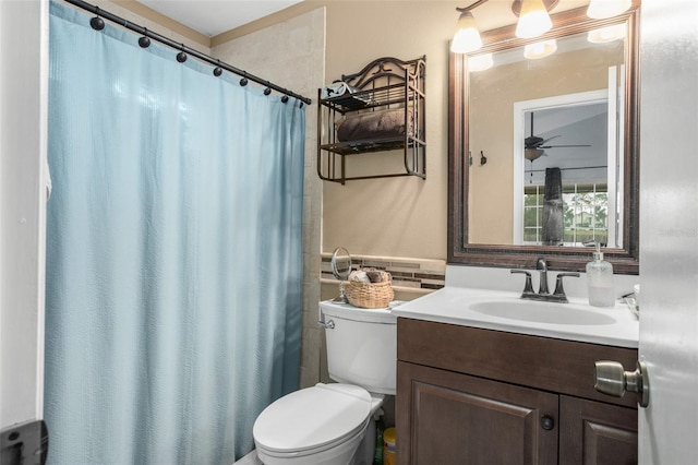 bathroom featuring vanity, curtained shower, and toilet