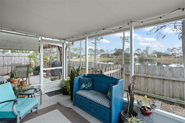 sunroom / solarium with a water view