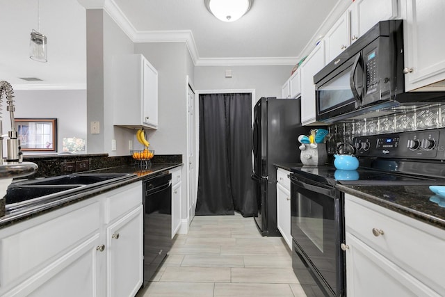 kitchen featuring white cabinetry, ornamental molding, dark stone countertops, and black appliances