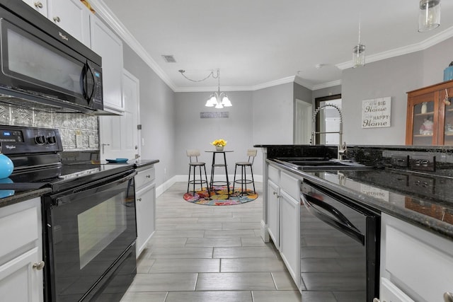 kitchen featuring sink, black appliances, dark stone countertops, pendant lighting, and white cabinets