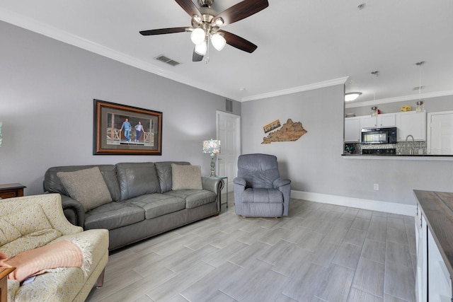 living room with crown molding and ceiling fan