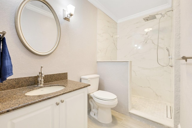 bathroom with ornamental molding, tiled shower, vanity, and toilet