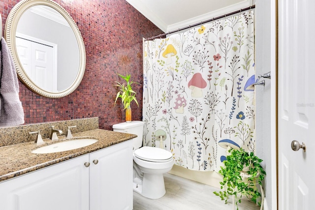 bathroom with vanity, ornamental molding, brick wall, curtained shower, and toilet