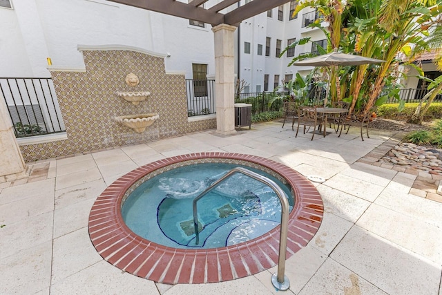 view of pool with a patio and a community hot tub