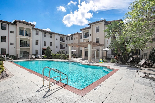 view of pool with a pergola and a patio