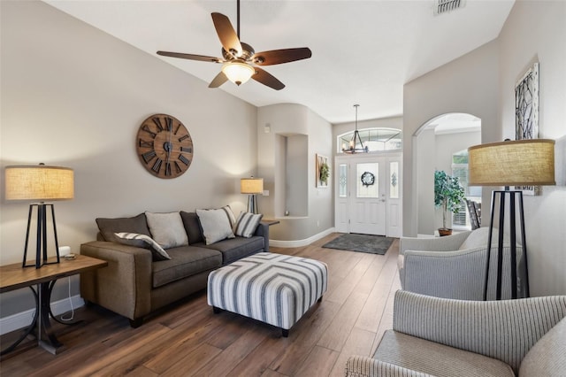 living room featuring ceiling fan and dark hardwood / wood-style flooring