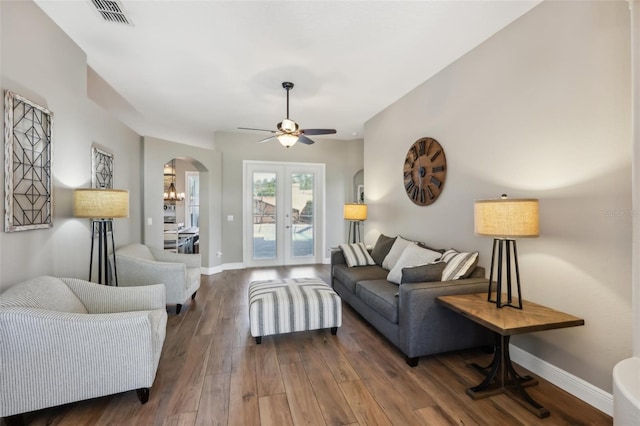 living room with ceiling fan, dark hardwood / wood-style flooring, and french doors