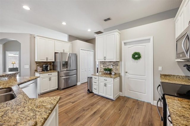 kitchen featuring white cabinetry, light hardwood / wood-style flooring, and stainless steel appliances