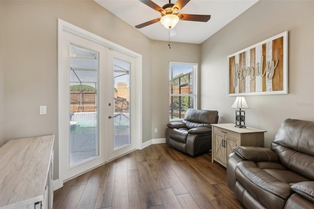 sitting room with dark wood-type flooring, french doors, and ceiling fan