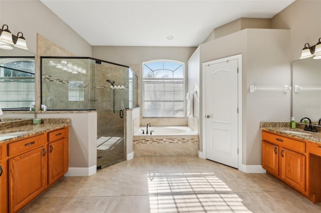 bathroom featuring shower with separate bathtub, vanity, and tile patterned floors