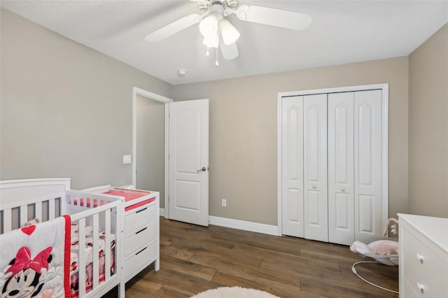 bedroom featuring ceiling fan, dark hardwood / wood-style flooring, and a closet