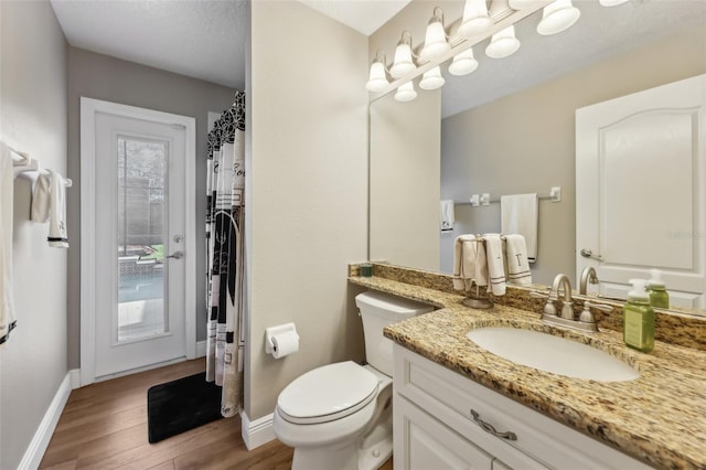 bathroom featuring hardwood / wood-style flooring, vanity, and toilet