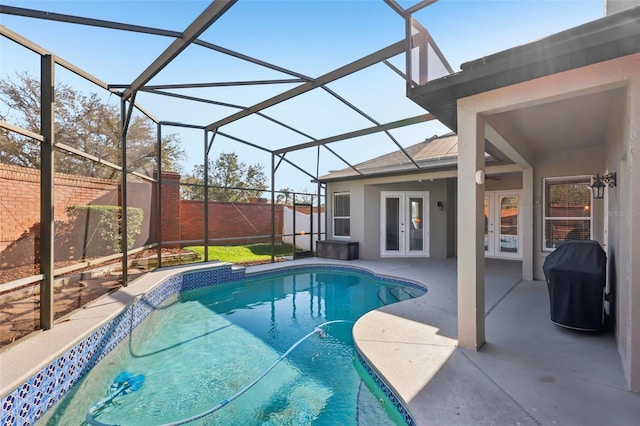 view of swimming pool featuring a patio, a grill, a lanai, and french doors