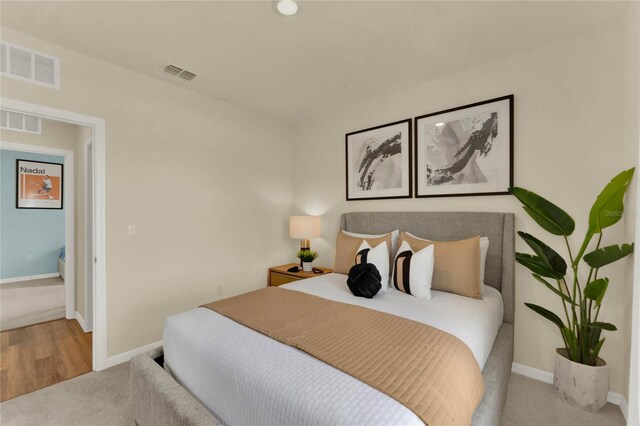 bedroom featuring light carpet