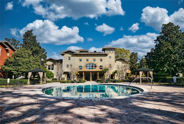 view of swimming pool featuring a gazebo and a patio area