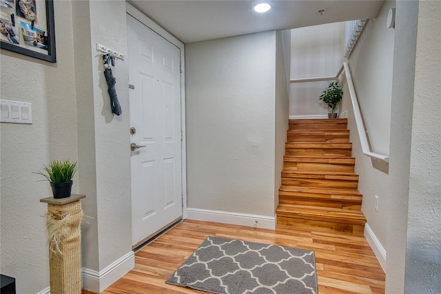 entryway with hardwood / wood-style flooring