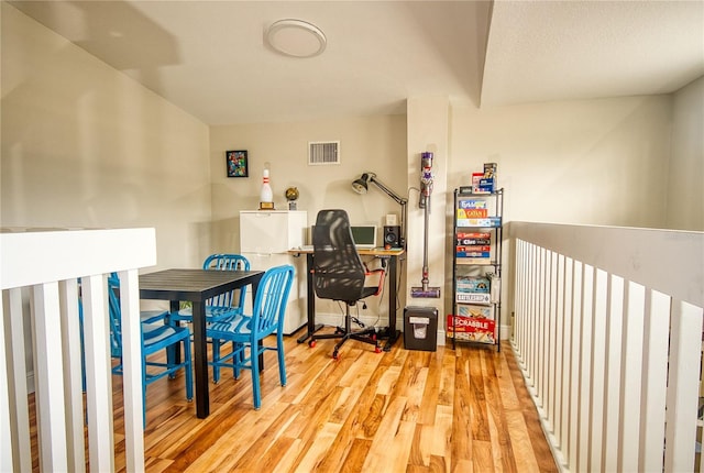 home office with light hardwood / wood-style floors