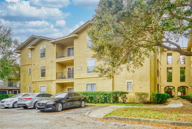 view of building exterior featuring uncovered parking