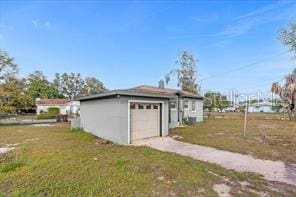 view of home's exterior with a garage and a yard