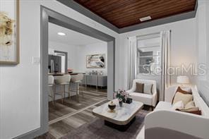 living room featuring dark hardwood / wood-style flooring and wood ceiling